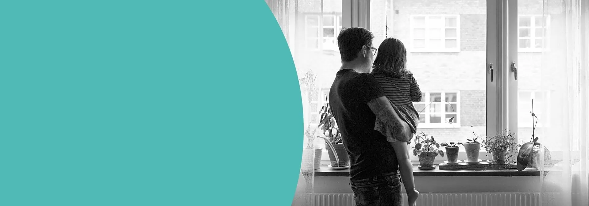 Father holding daughter up to window 