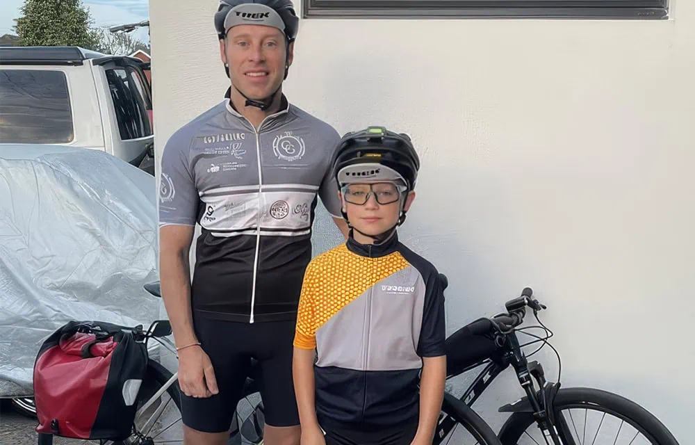 Young boy and adult male ready for cycling adventure outdoors.