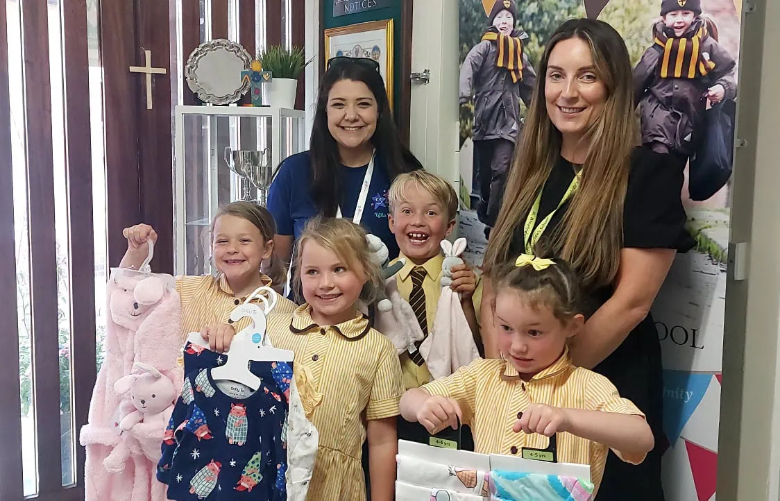 Happy children and teachers at Little Stars nursery.