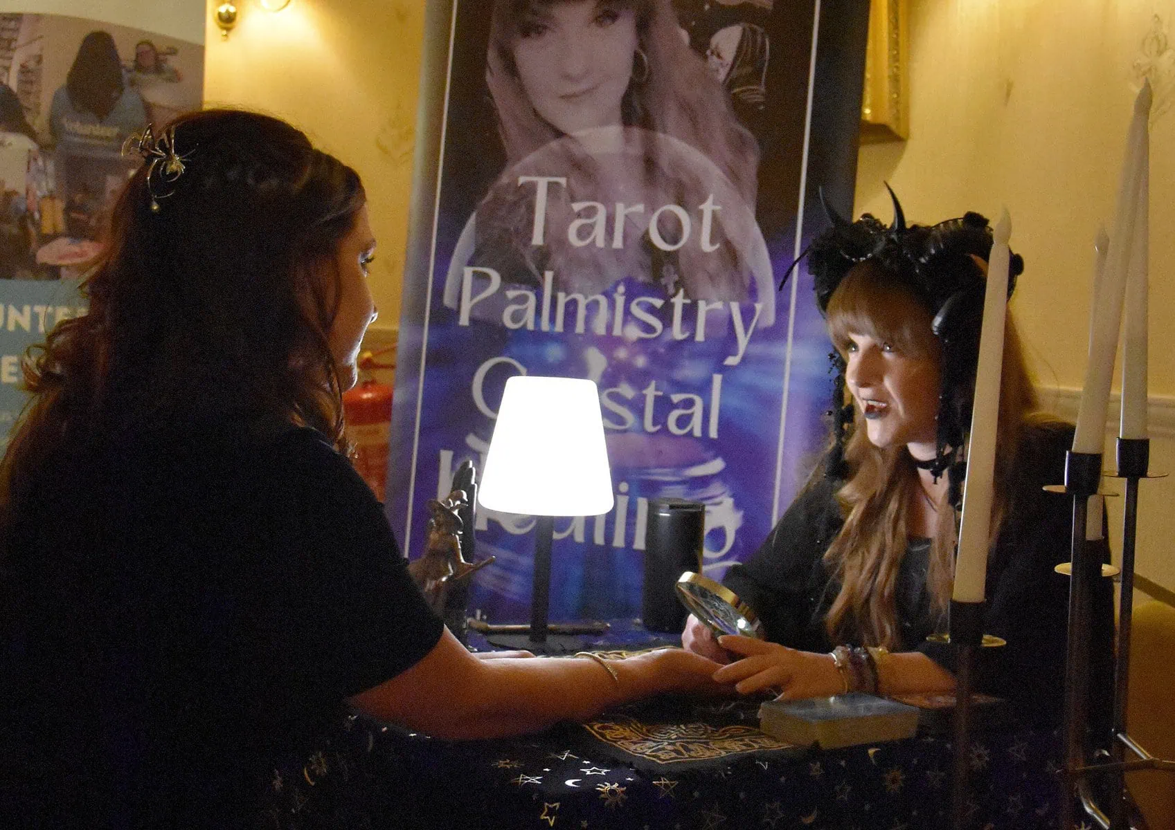 Woman having tarot reading session at Little Stars, palmistry, and crystal reading event.