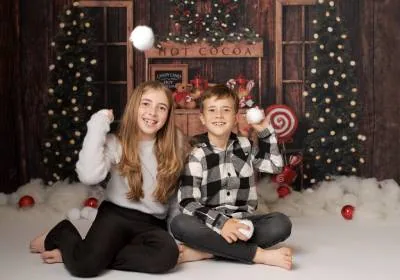Children sat in front of a christmas fireplace