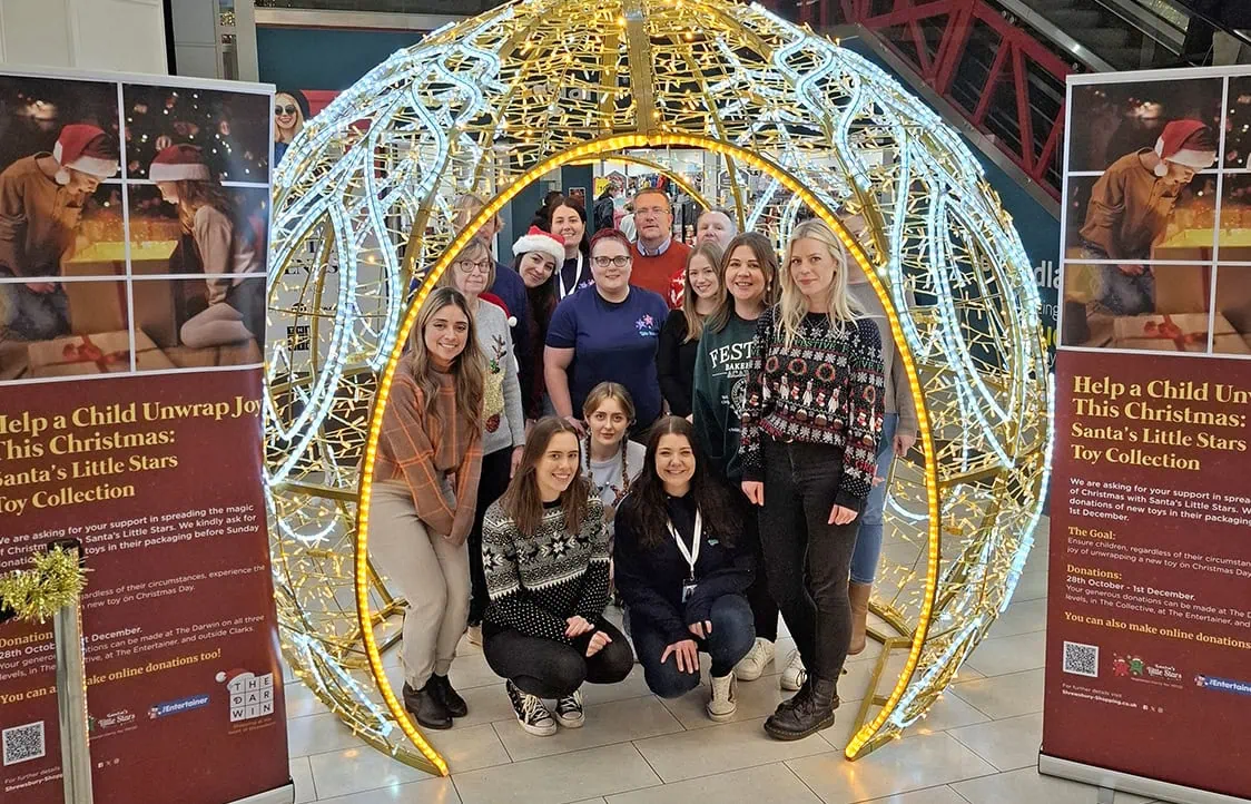 Bright Christmas light display featuring a group supporting Santa's Little Stars Toy Collection.